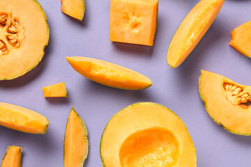 Pieces of sweet melon on lilac background