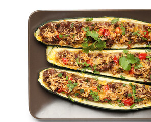 Plate with meat stuffed zucchini boats on white background