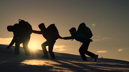 Climbers man woman hand in hand. Teamwork business people partner. Silhouette of group of tourists,...