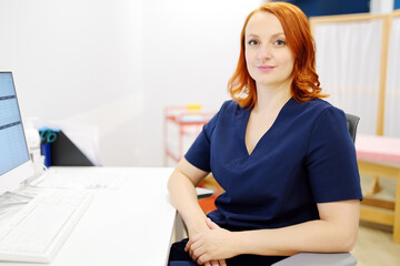 Portrait of a smiling female neurologist looking at camera in the office of a modern clinic. The...