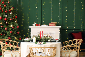 Festive table setting in stylish living room with Christmas tree and fireplace