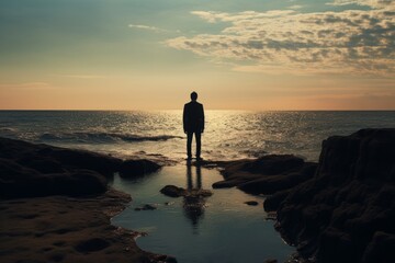 Naklejka premium Man standing on shore. Sunrise scenery. Generate Ai