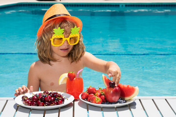 Healthy food. Outdoor leisure activity with kids by swimming pool. Summertime. Summer child by the...