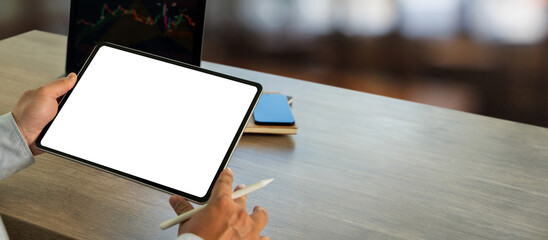 A businessman holds a mockup. digital tablet with blank screen Mockup replaces your design mockup...