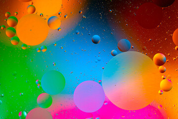 movement of oil bubbles in the liquid. Fantastic structure of colorful bubbles. Colorful artistic image of oil drop floating on the water