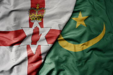 big waving national colorful flag of mauritania and national flag of northern ireland .