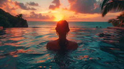 Fototapete Bora Bora, Französisch-Polynesien Paradise luxury resort honeymoon getaway idyllic Caribbean tropical hotel, a woman silhouette swimming in infinity pool watching sunset serene getaway at dusk