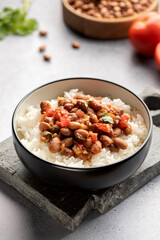 Vegan bean curry with rice and tomatoes. Indian cuisine. Vegetarian dish. 