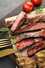 Delicious grilled beef with vegetables and rosemary served on table, top view