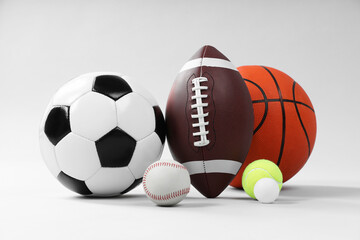 Many different sports balls on light gray background