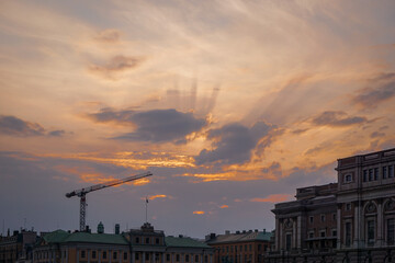 Low angle view of construction crane against sky during sunset