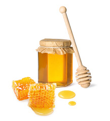 Natural honey in jar, wooden dipper and pieces of honeycomb on white background