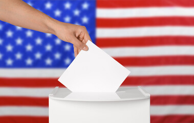 Election in USA. Man putting his vote into ballot box against national flag of United States, closeup. Banner design - obrazy, fototapety, plakaty