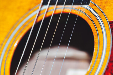 Acoustic guitar strings over the hole, shallow depth