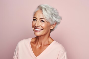Beauty is her life. Portrait of an attractive mature woman smiling while standing against a pink background