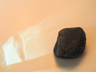 Rocks on a minimalist pastel colored glare background for product display.  