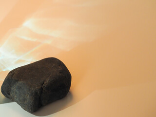Rocks on a minimalist pastel colored glare background for product display.  
