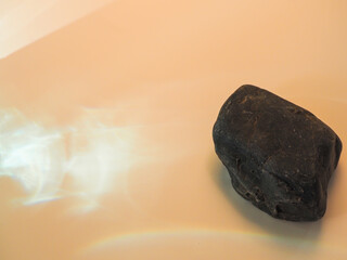 Rocks on a minimalist pastel colored glare background for product display.  