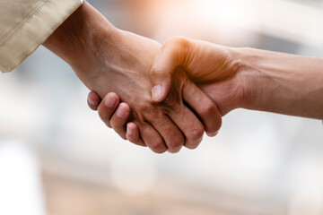 Arab Businessman shaking hands together. Teamwork business partner wear Muslim dress Shake Hands with Partnership Concept. Success UAE diversity people trust make commitment by handshake