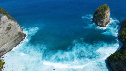 Turquoise ocean sea water white wave splashing deep blue sea. Bird eye view monster wave splash on...