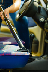 Cleaning car interior with vacuum cleaner