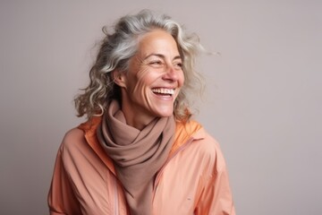 Portrait of a happy senior woman laughing and looking at the camera