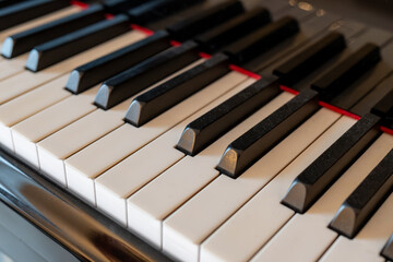 Old grand piano with ivory keys close up