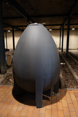 WIne celler with french concrete egg shape wine tank for aging of red wine, Haut-Medoc vineyards in...
