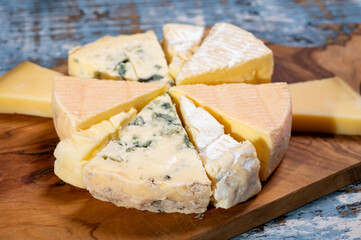 Tasting plate with small pieces of different French cheeses, variety of cheeses