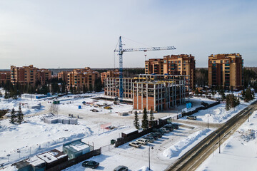 Fototapeta premium the construction site of an apartment building in the winter from a height