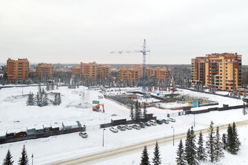 the construction site of an apartment building in the winter from a height