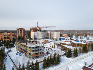 the construction site of an apartment building in the winter from a height