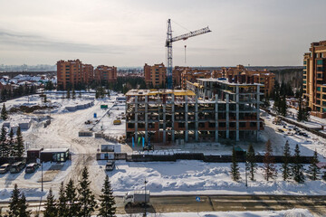 the construction site of an apartment building in the winter from a height