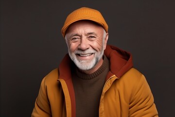 Portrait of a happy senior man in a yellow jacket and hat