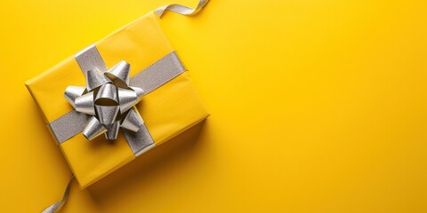 Yellow gift box with ribbon. Copy space background - obrazy, fototapety, plakaty
