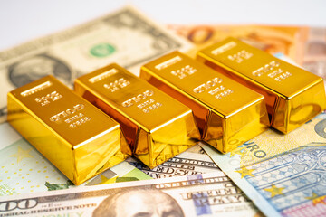 Gold bar on US dollar and Euro banknote, economy finance exchange trade investment.