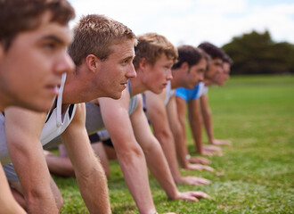Group, men and field for push up with fitness, training and health with friends for sport, challenge or wellness. People, athlete and teamwork with exercise, workout and together on field for muscle