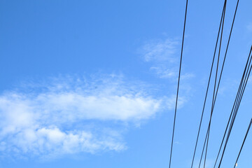 Fototapeta premium blue-sky electricity with awesome clouds at morning-afternoon. Electric wire, viewed over blue sky.