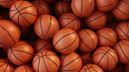 A pile of basketballs are stacked on top of each other.