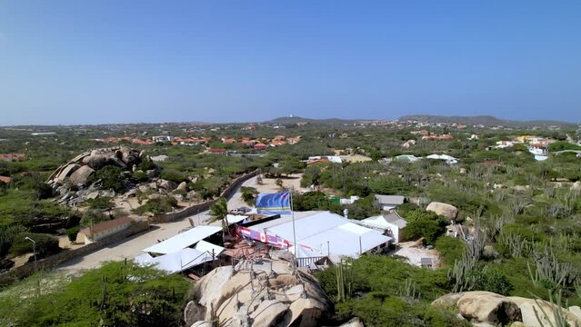 Aruban flag flapping near Ayo Rock Formation in Aruba near Oranjestad