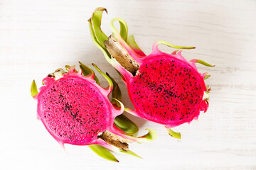 Red dragon fruit on white wooden background.