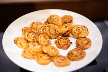 Baked homemade bakery, Danish or tart pie are served in plate at morning breakfast buffet. Close-up and selective focus at the center part, Bakery food photo.