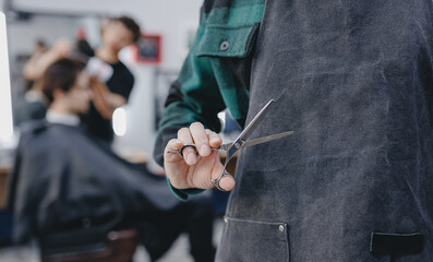 Banner Barber shop for man. Closeup hands of hairdresser holds scissors on background barbershop