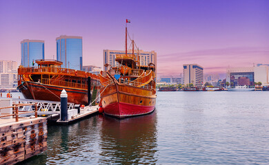 Old wooden ship for tourist cruise Dhow in Dubai Marina, United Arab Emirates.