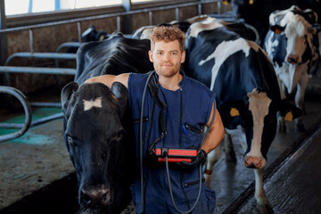 Veterinarian man with ultrasound device hugs cow pregnant on farm. Concept love to animals and health care for cattle, artificial insemination