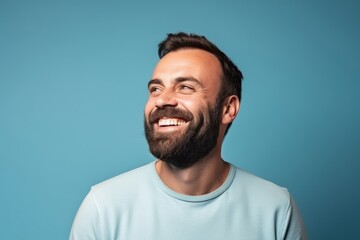 Portrait of a happy man with beard and mustache over blue background