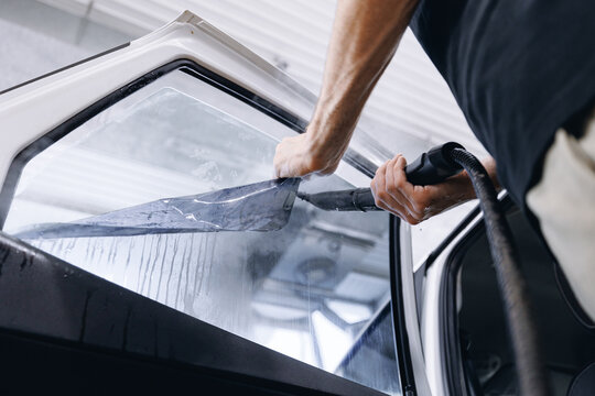 Process remove protective vinyl tint film from car. Transparent protection for window vs sun