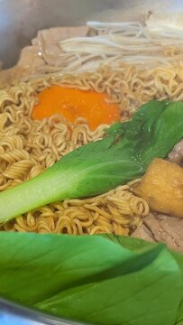 Korean foods served on a dining table. Perfect article, or any cooking contents. traditional hot pot combo, sweet garlic, and beef slices. It is very popular in sichuan