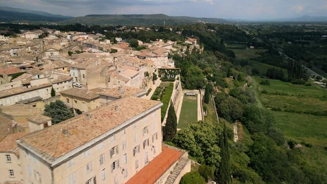Drone descends along Lauris France homes overlooking vineyard fields in the countryside