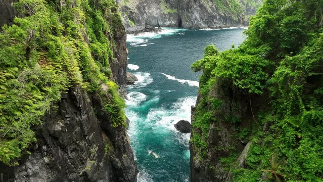 Aerial views through valley of Orong Bukal cliff jumping location on Lombok Island, Indonesia.